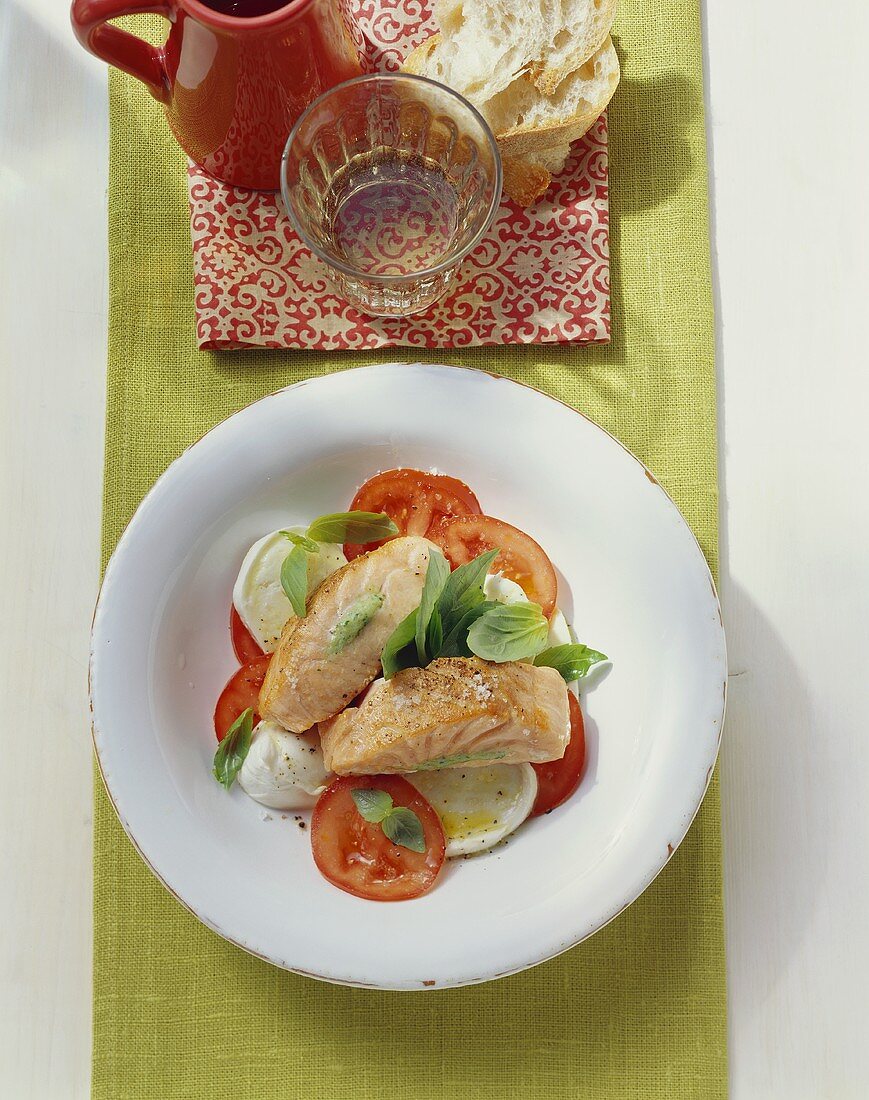 Salmon with basil stuffing on tomato and mozzarella salad