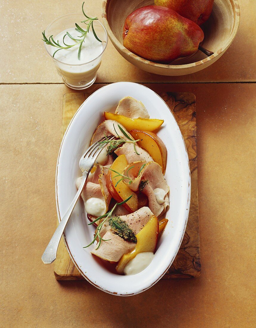 Cold roast pork and pear slices with cheese sauce