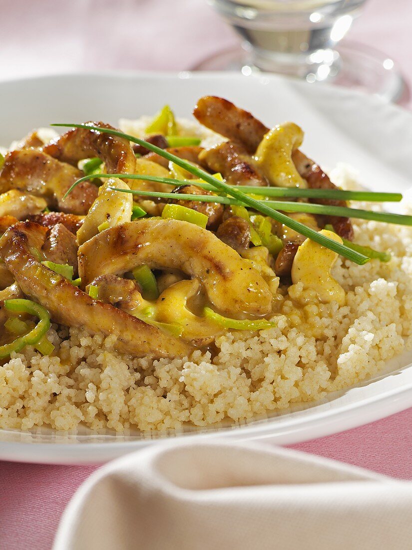 Curried meat with cashew nuts on couscous
