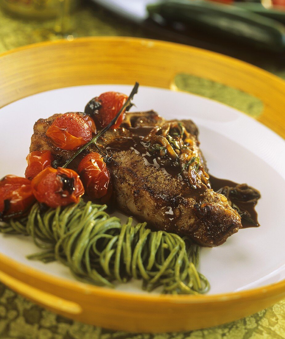 Spicy veal cutlet with tarragon, green noodles & tomatoes