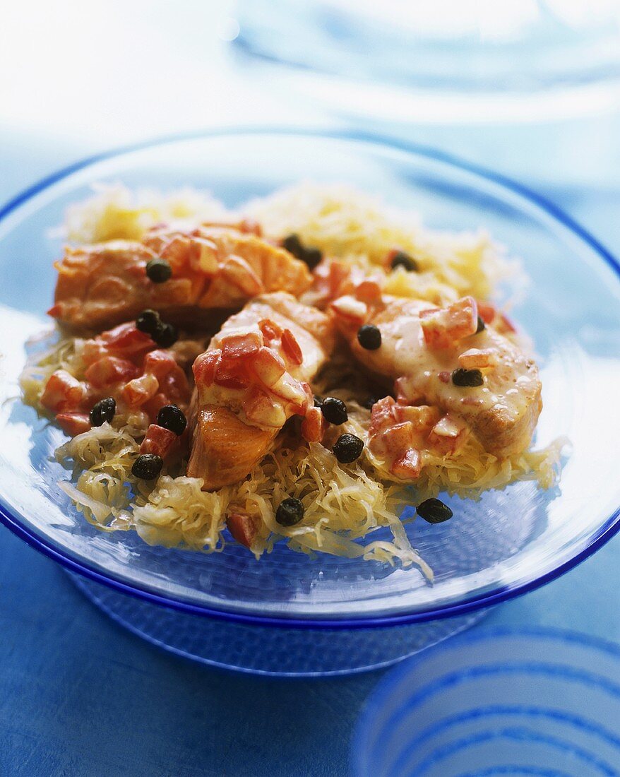 Salmon with tomatoes and capers on sauerkraut