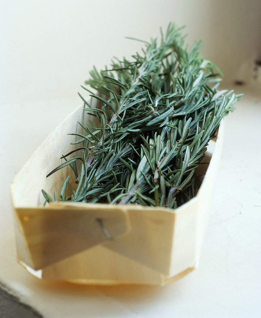 Sprigs of rosemary in a woodchip basket
