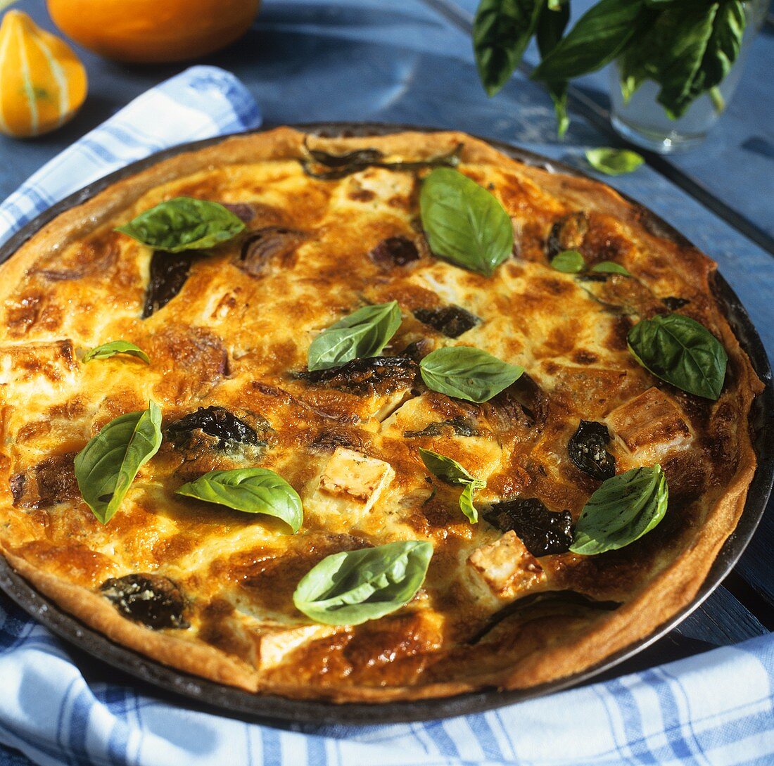 Hearty pumpkin tart with sheep's cheese, onions and basil
