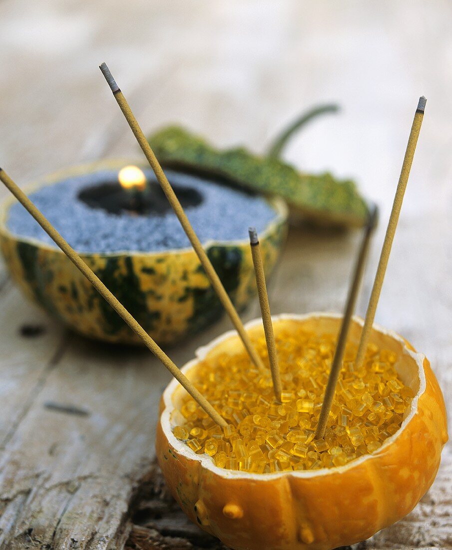 Pumpkins filled with coloured stones to hold joss sticks