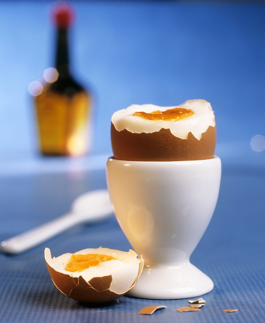 Boiled egg with top cut off in eggcup