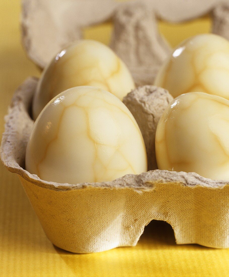 Marbled boiled eggs in an egg box