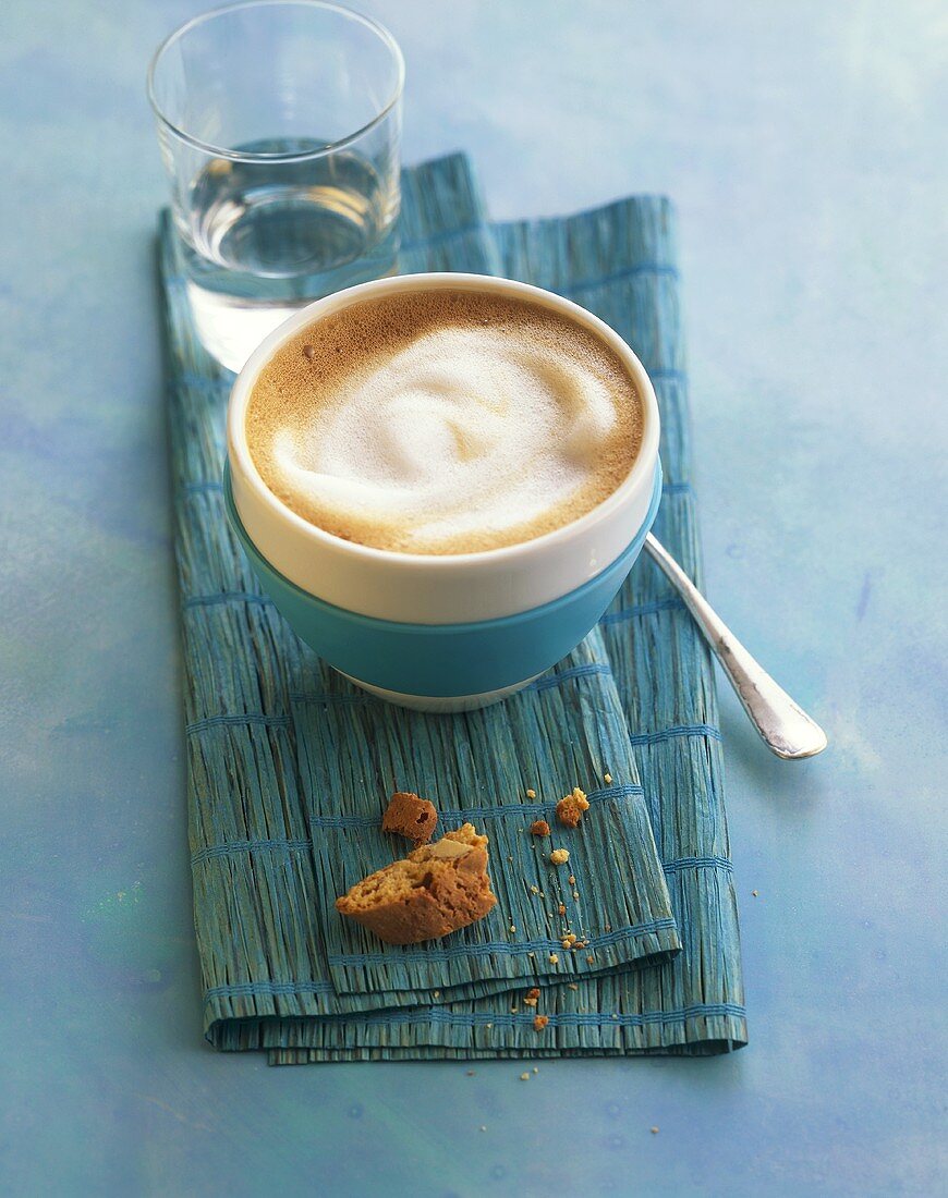 Milky coffee on blue background