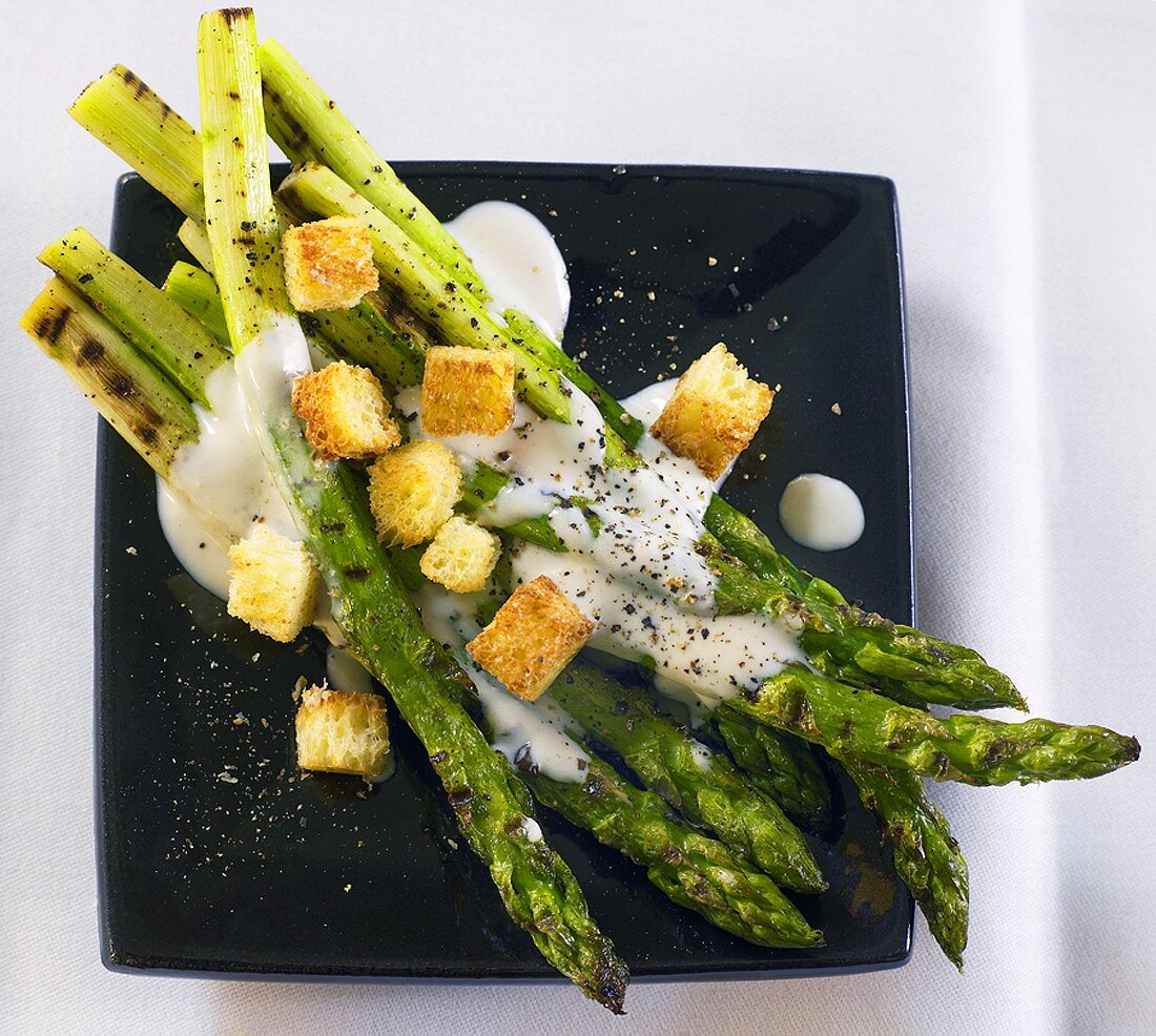 Grilled green asparagus with Caesar salad dressing