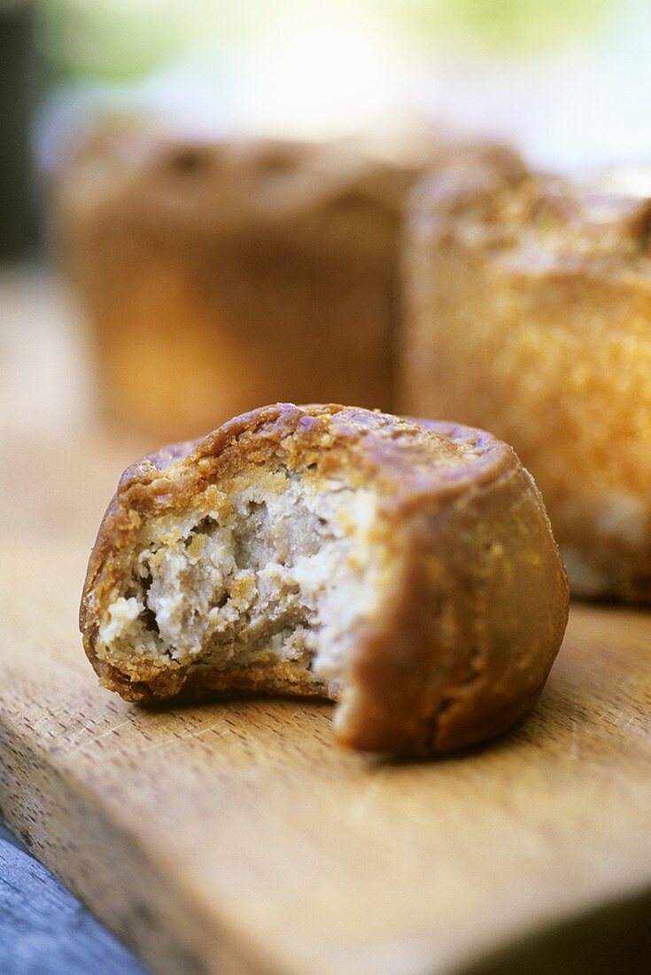 Pork pies on wooden board (UK)