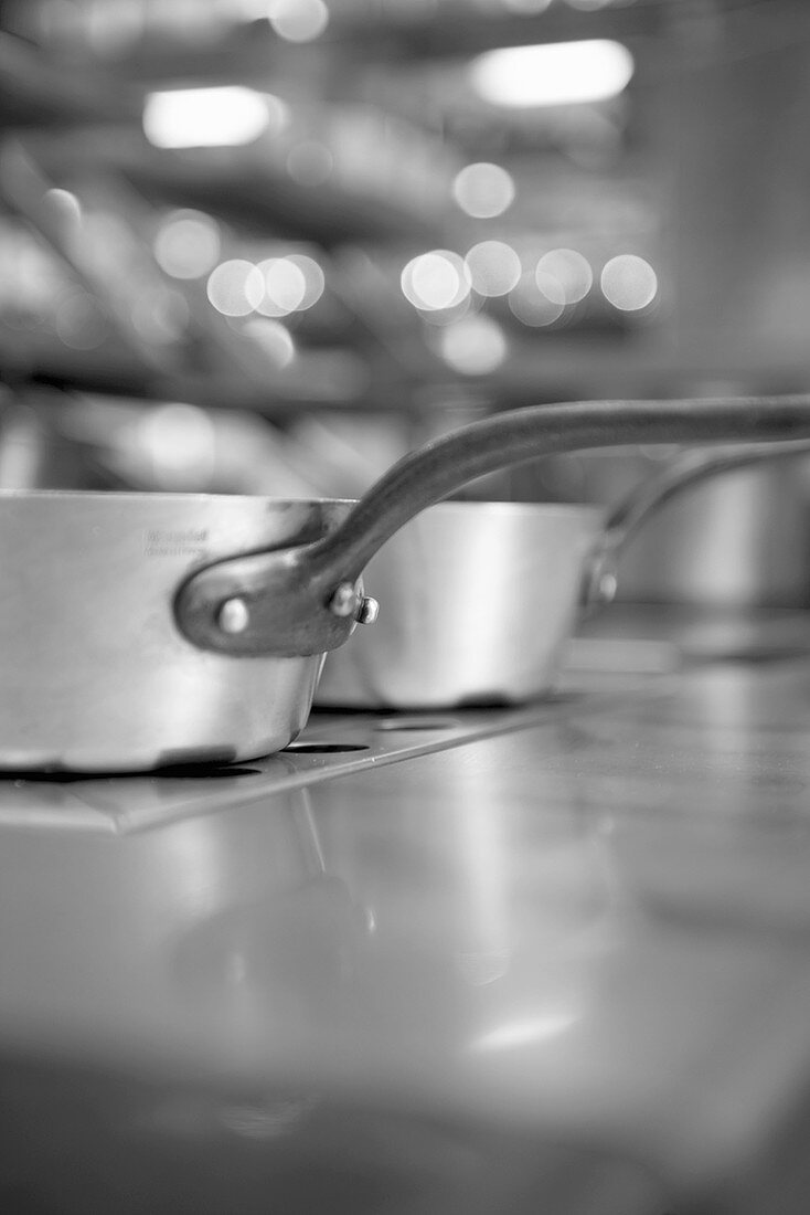 Kitchen, focus on saucepans, black & white photo