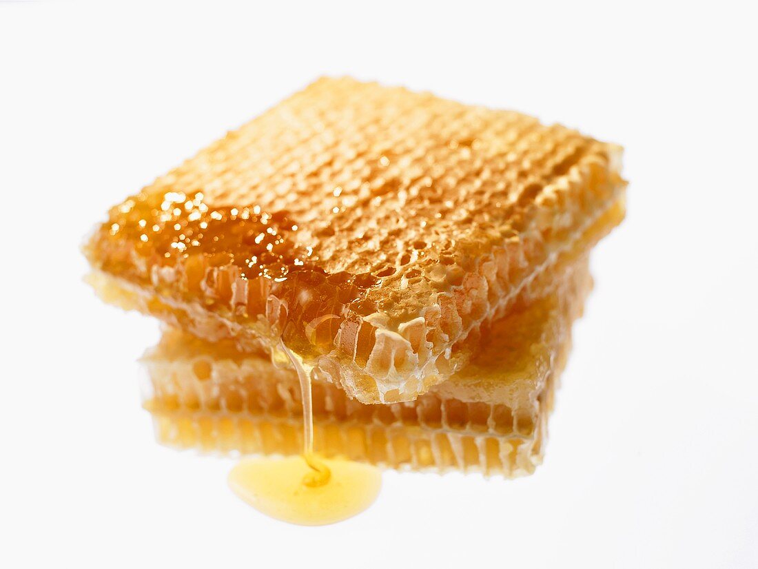 Two pieces of honeycomb with white background