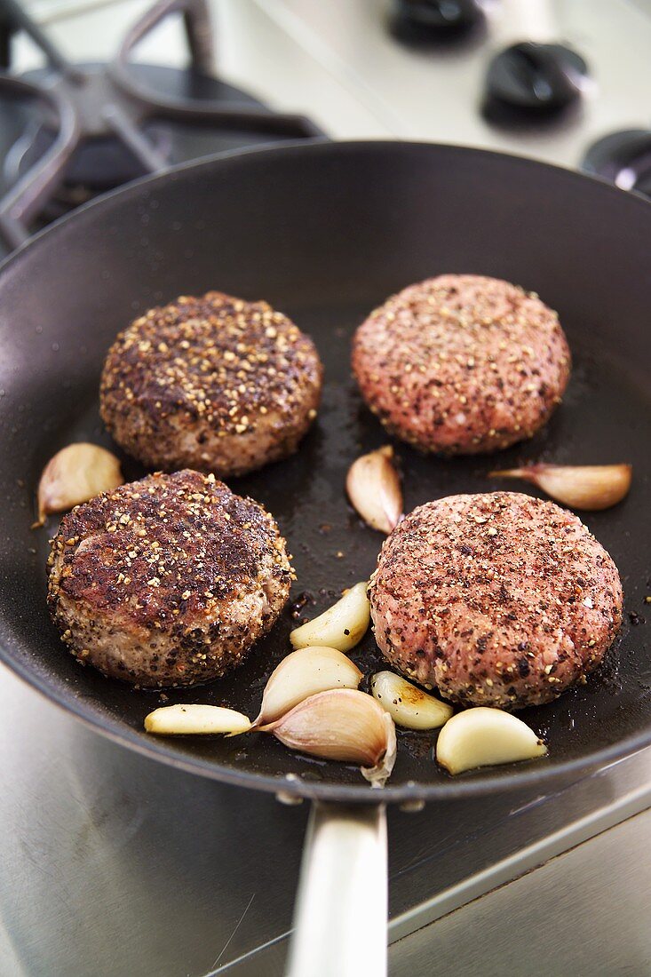 Frying burgers in a frying pan