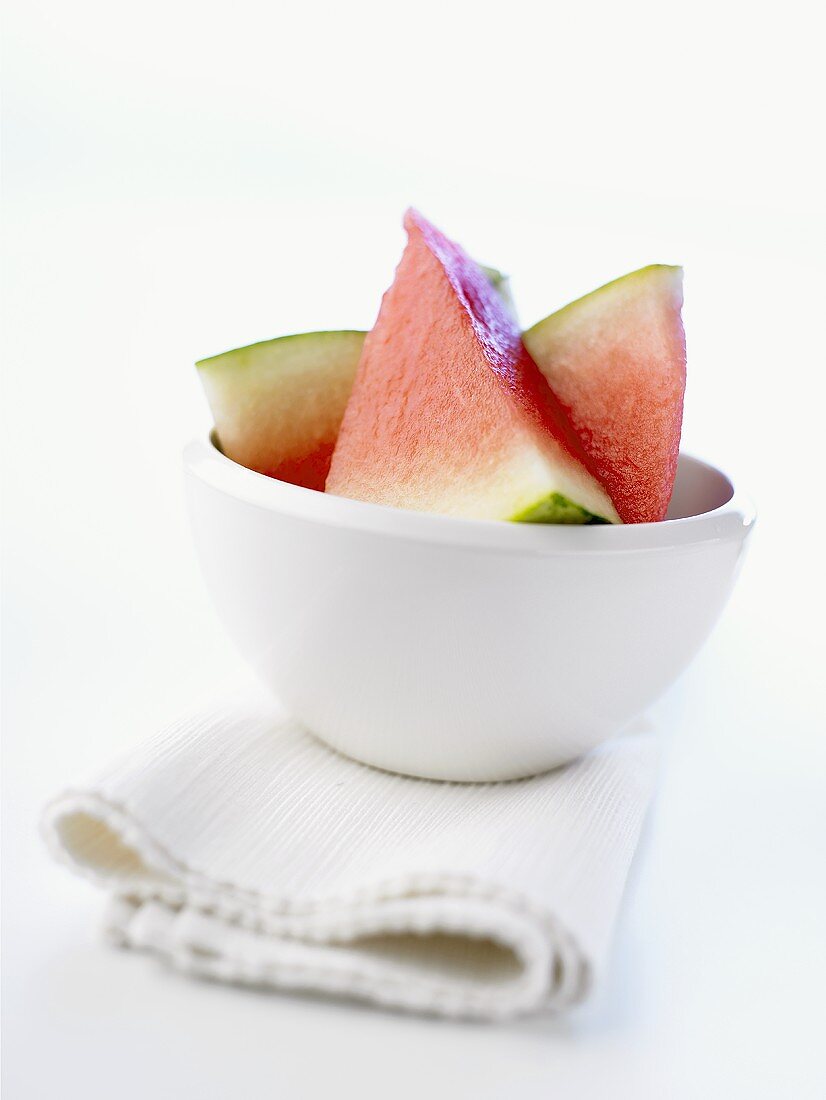 Several pieces of watermelon in a small bowl