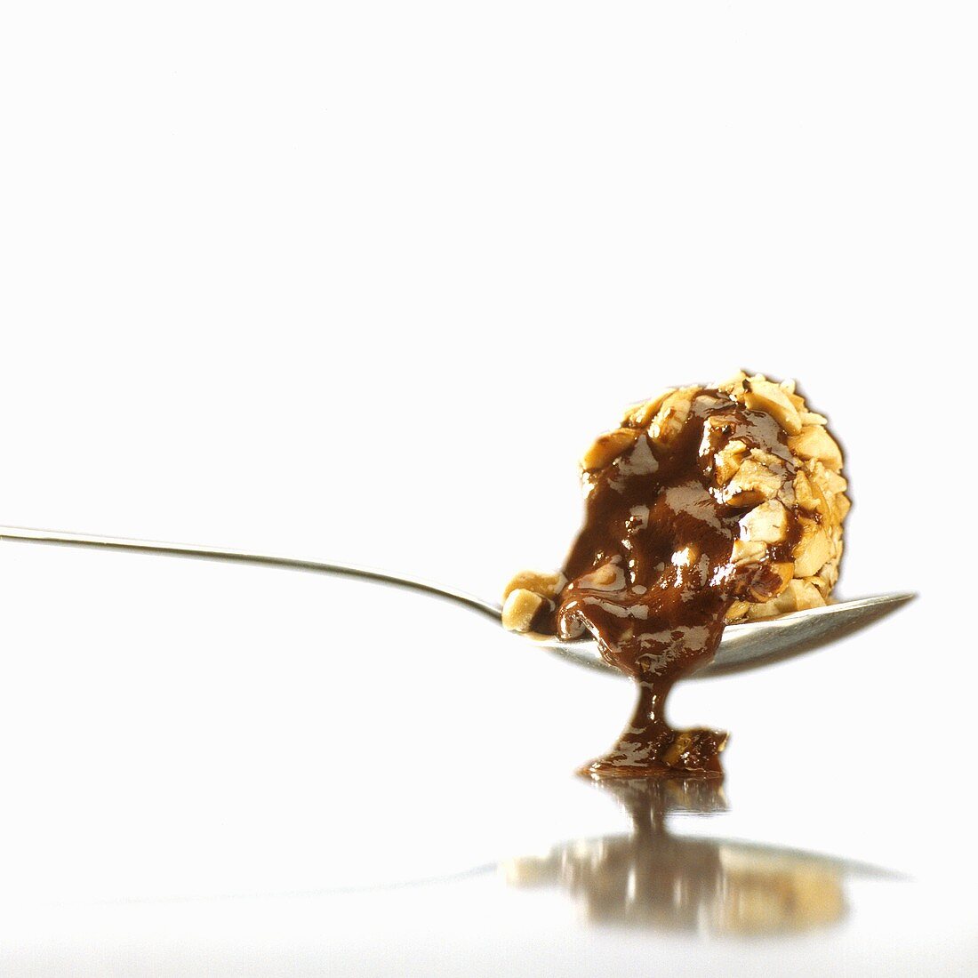 A melting chocolate truffle on a spoon