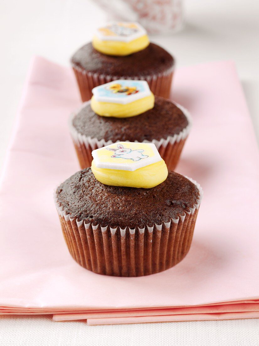 Three chocolate muffins with sweet decoration