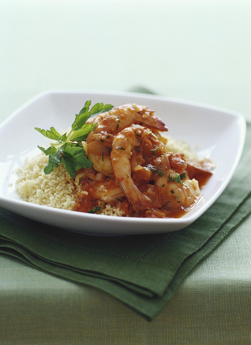 Spicy shrimps with tomato sauce on couscous