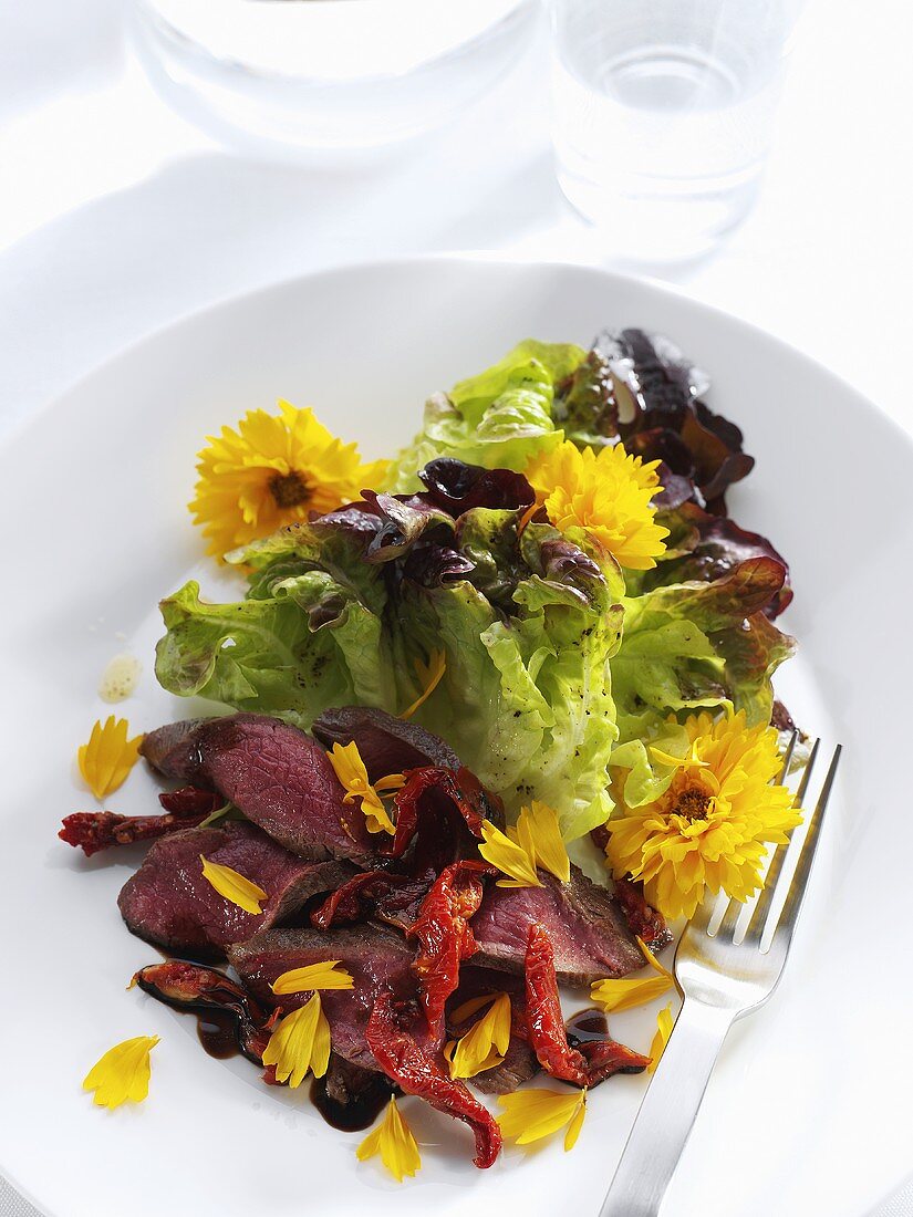Lamb with salad leaves and Calendula flowers