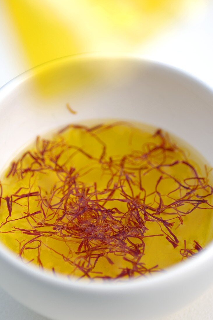 Saffron threads in a small bowl of water