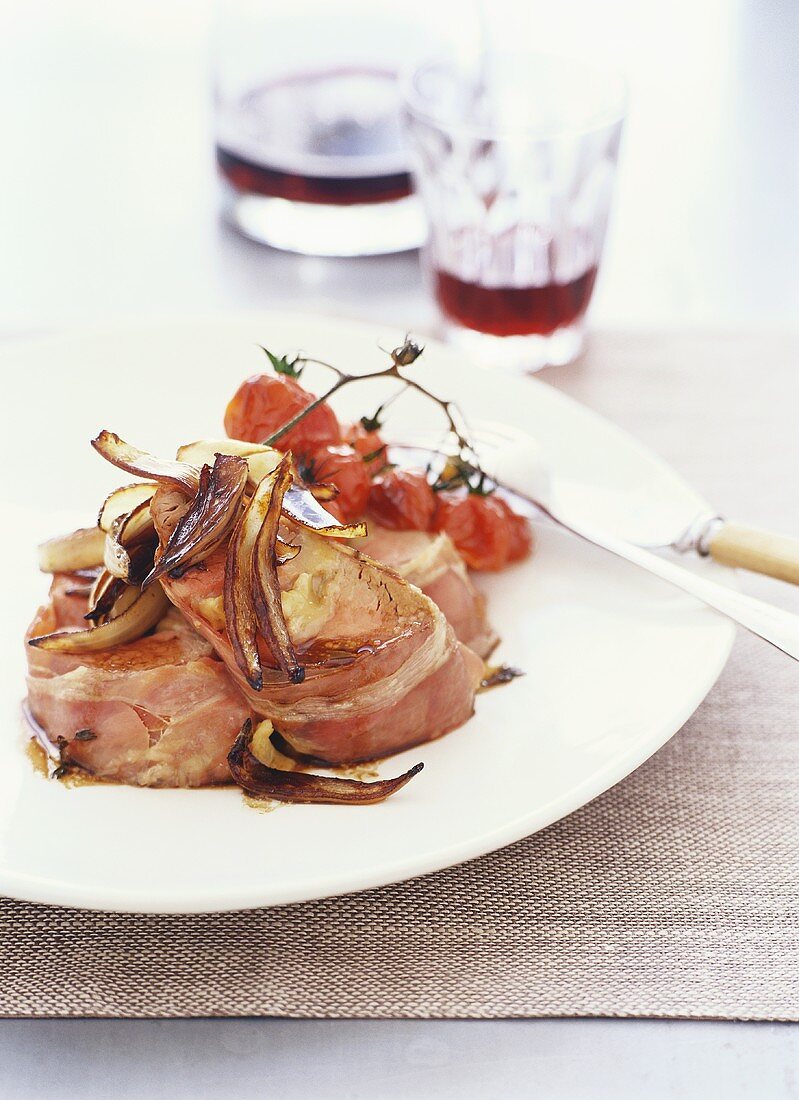 Veal wrapped in bacon with roasted cherry tomatoes