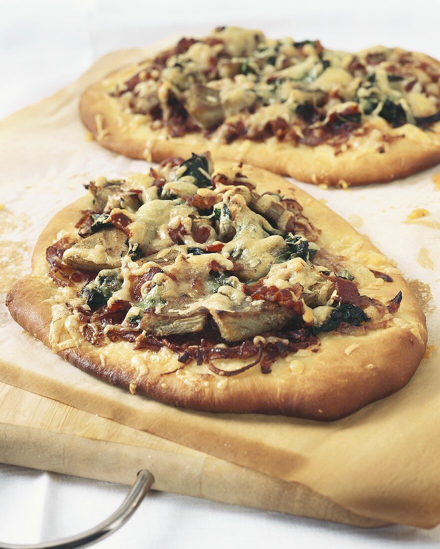 Pizzas with artichokes and spinach