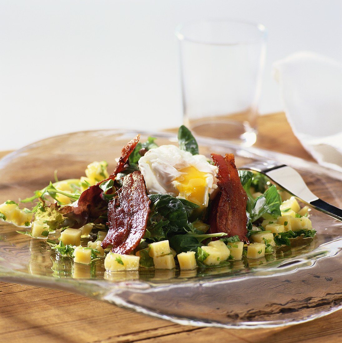 Cheese salad with spinach, bacon and poached egg