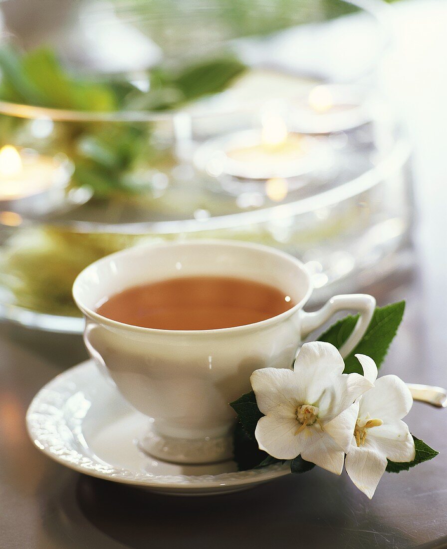 A cup of tea with campanula flowers