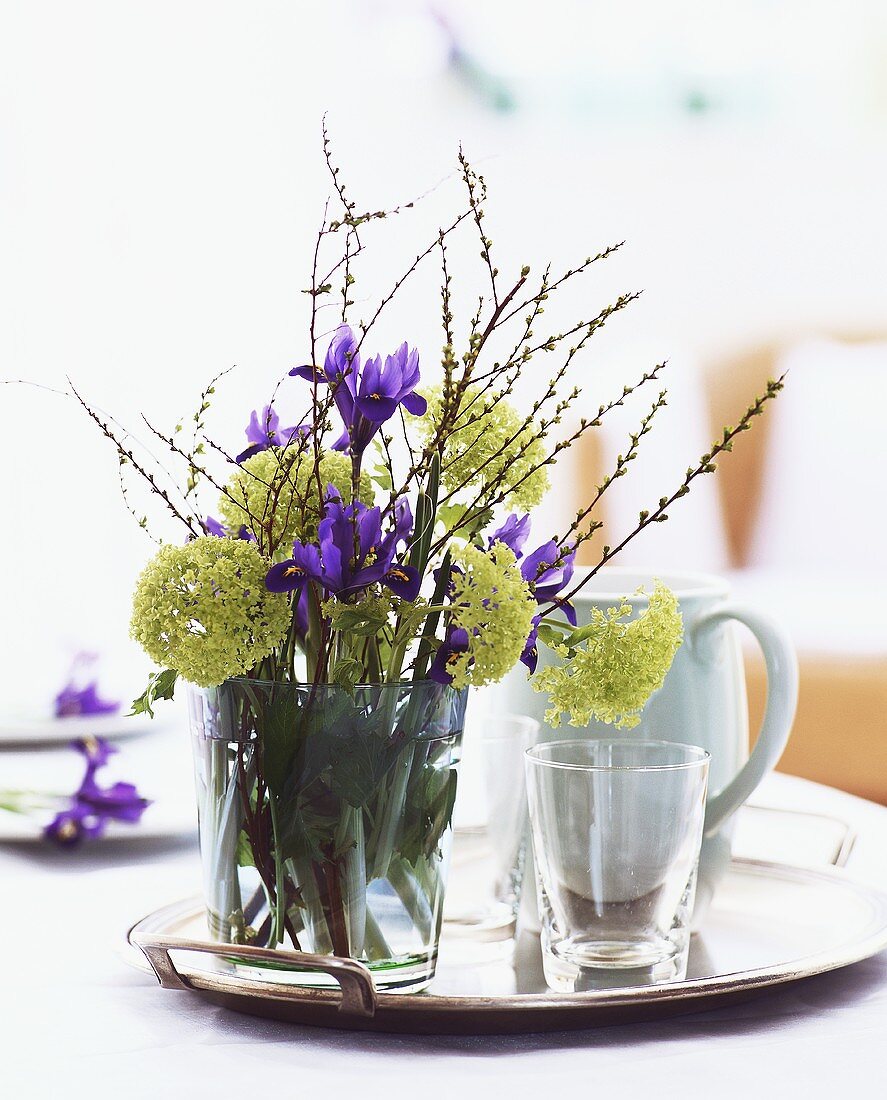 Posy of spring flowers on tray