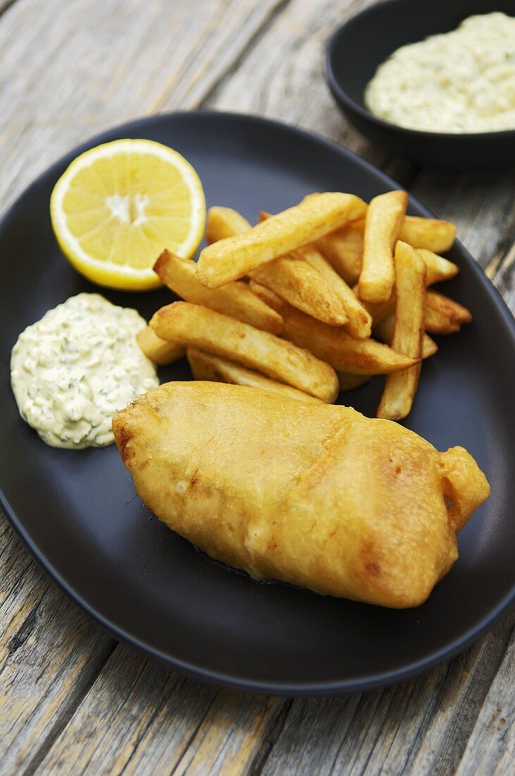 Deep-fried haddock in beer batter with chips and remoulade