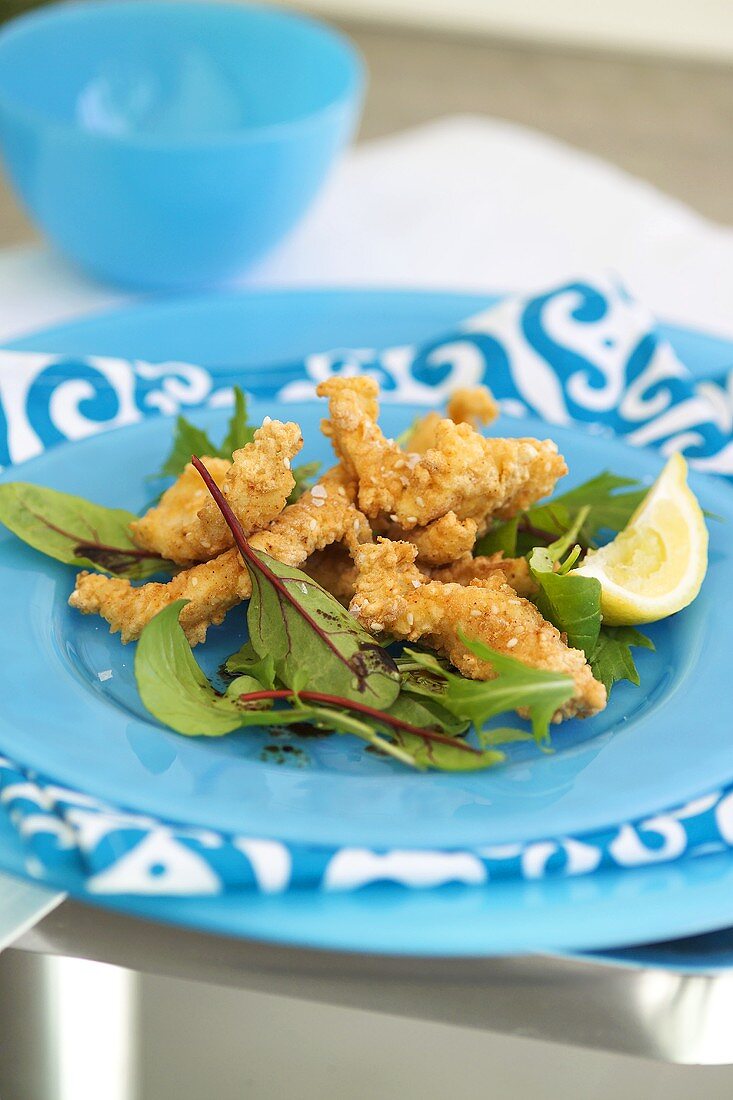 Deep-fried strips of sole with salad leaves