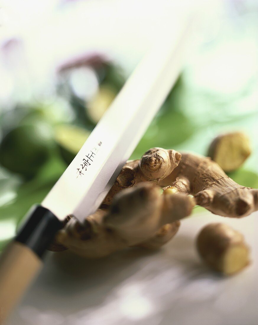 Ginger root with Asian kitchen knife