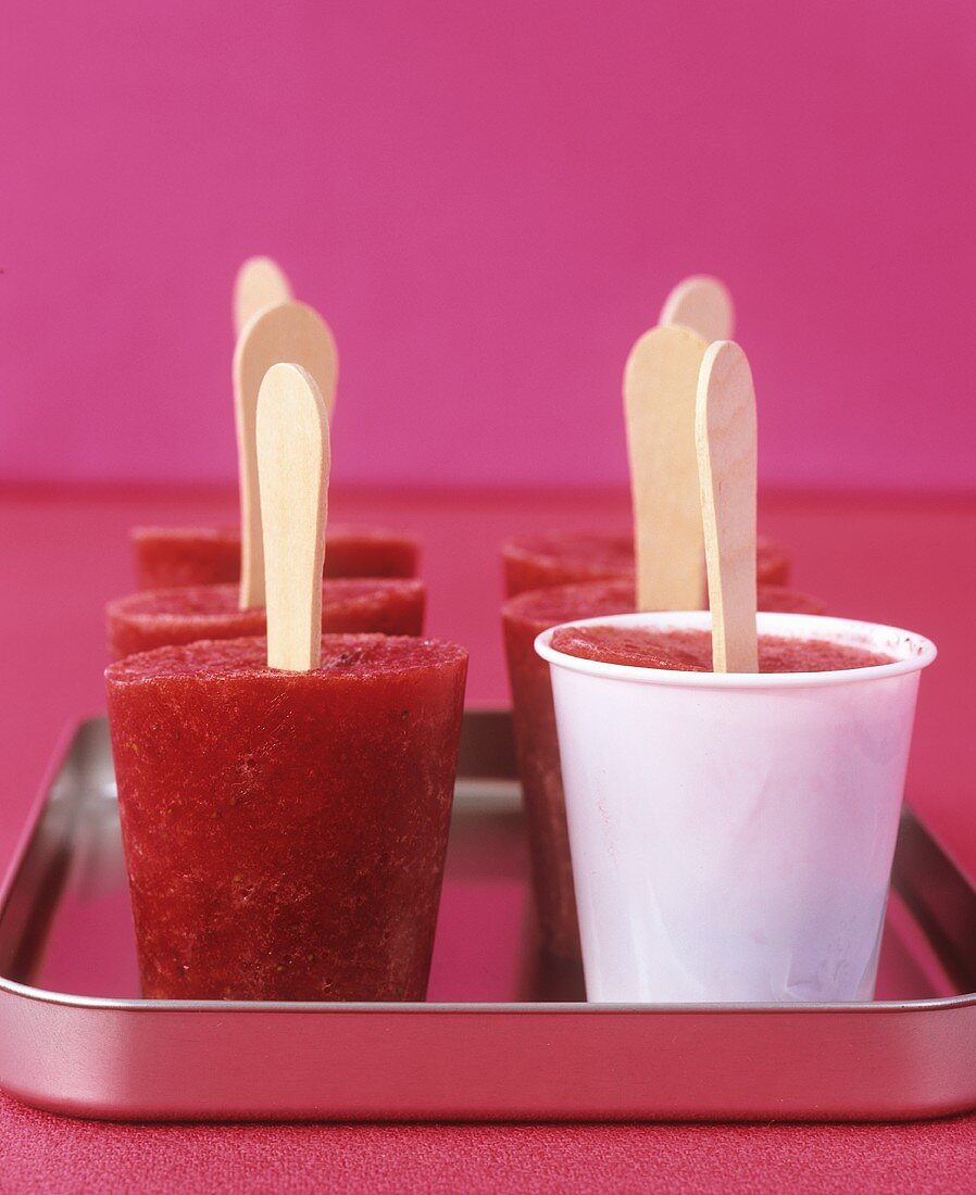 Home-made raspberry ice lollies