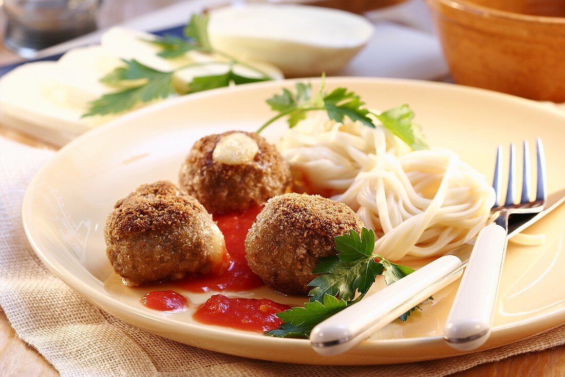 Meatballs and macaroni with tomato sauce