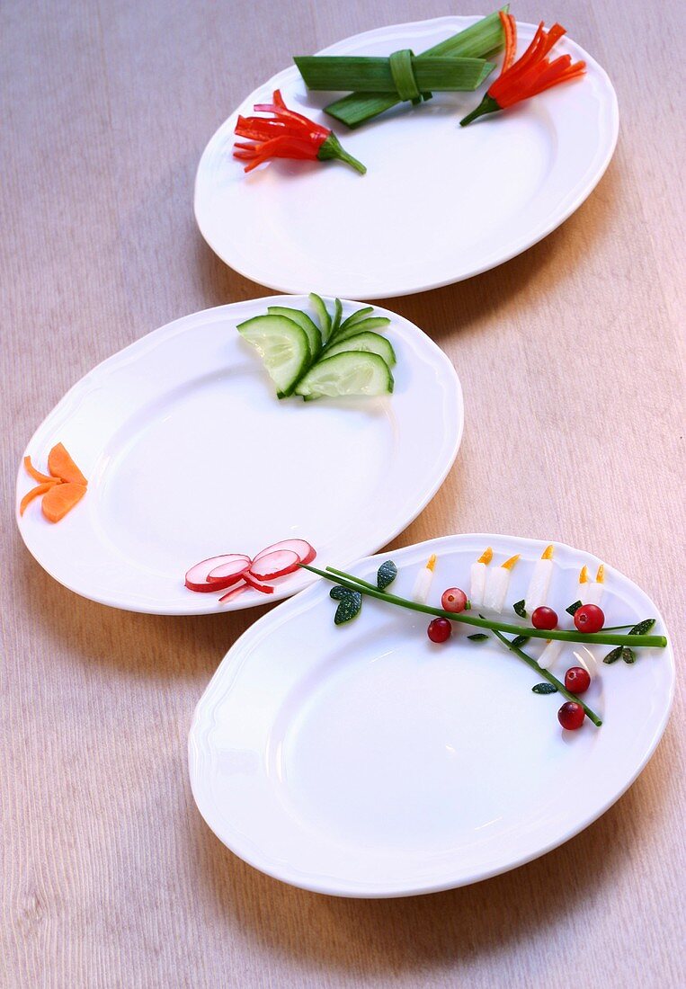 Three plates with vegetable decorations