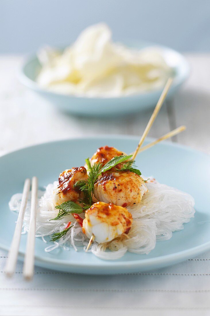 Spicy meat kebabs on glass noodles