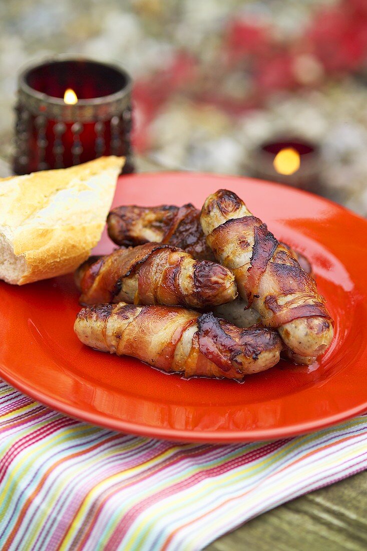 Pork sausages wrapped in bacon