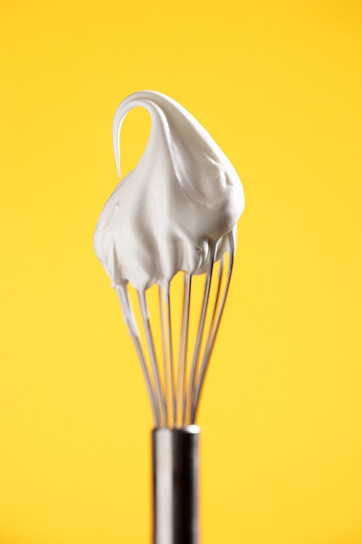 Beaten egg white on whisk