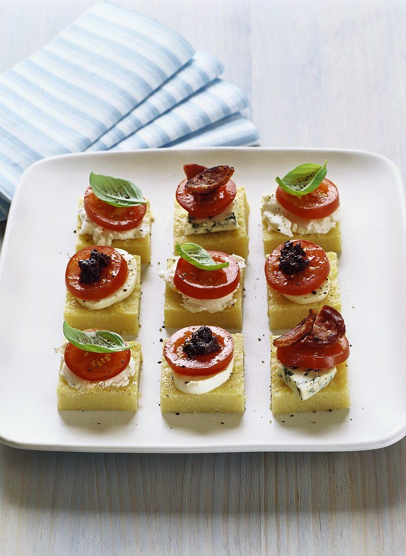Polenta slices with cherry tomatoes & cheese