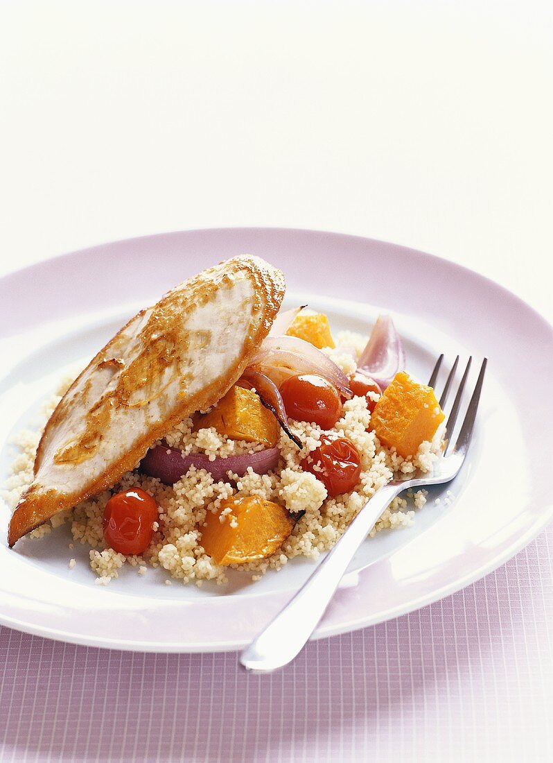 Fried chicken breast fillet with couscous salad