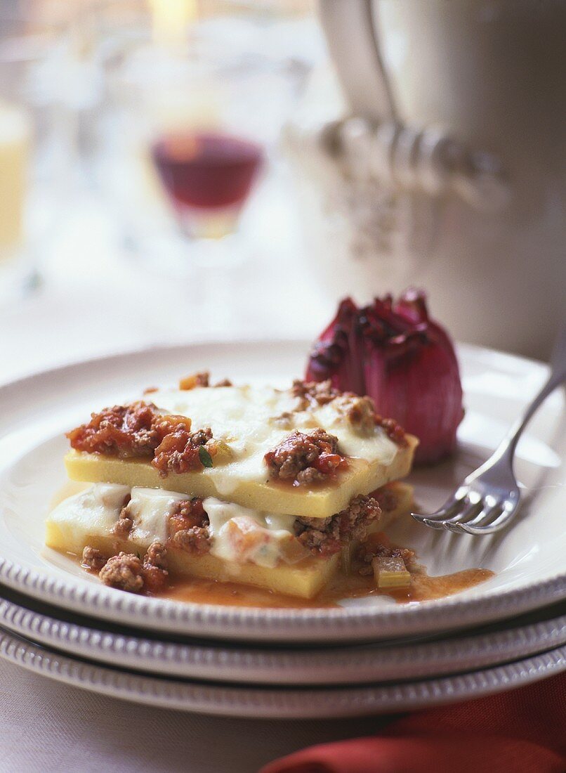 Polenta slices with mince sauce & cheese topping