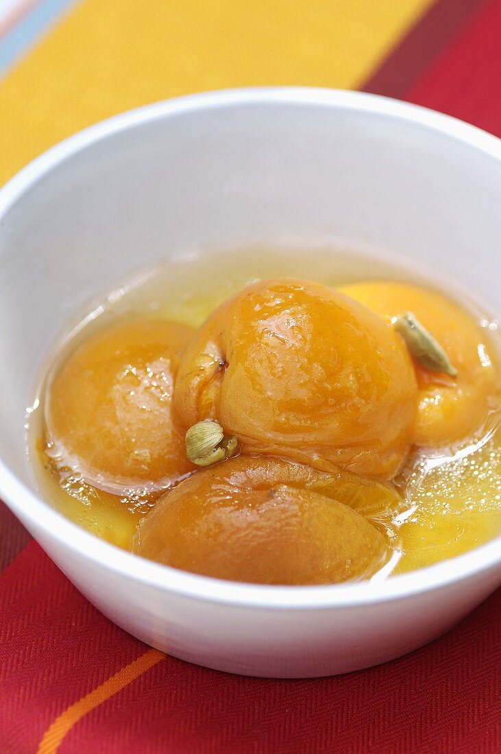Poached peaches in a small bowl