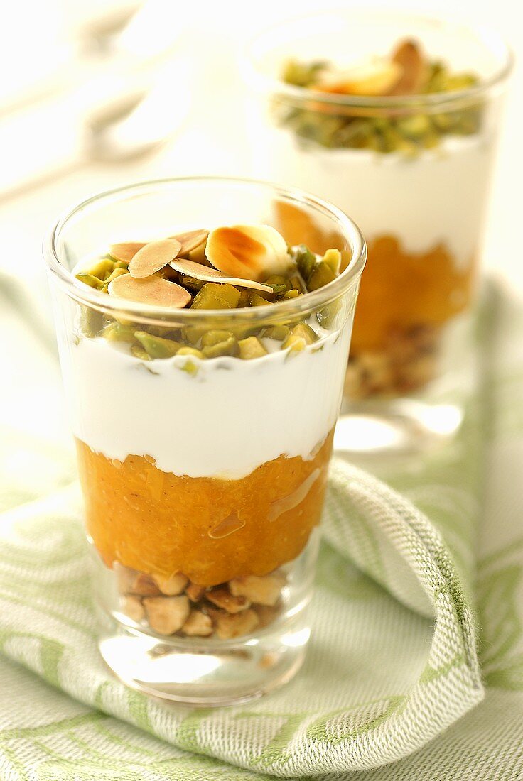 Layered dessert with nuts, apricots and yoghurt