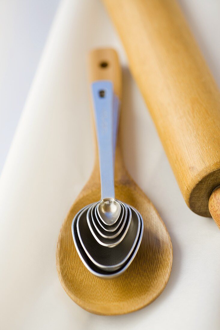 Wooden spoon, measuring spoons and rolling pin