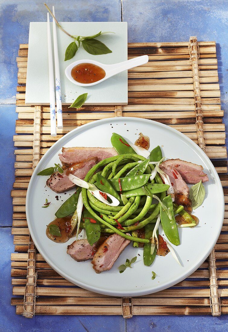Salad with roast duck breast and plum sauce