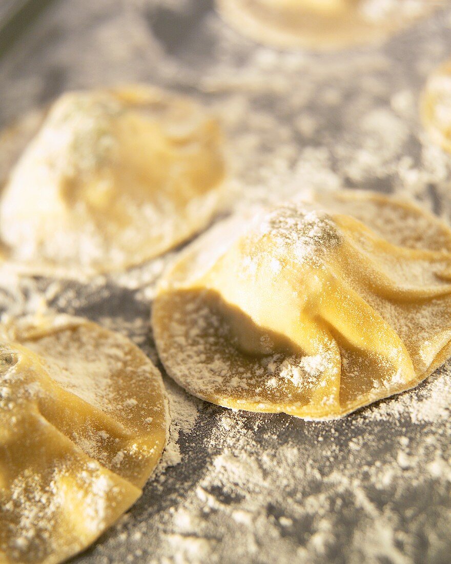 Sprinkling ravioli with flour