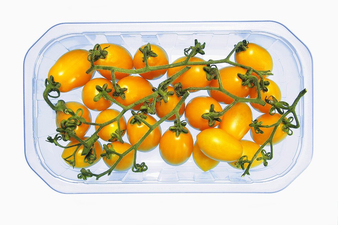 Yellow tomatoes in a plastic punnet