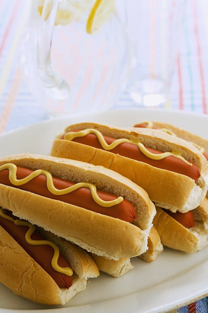 Hot dogs with mustard on a platter