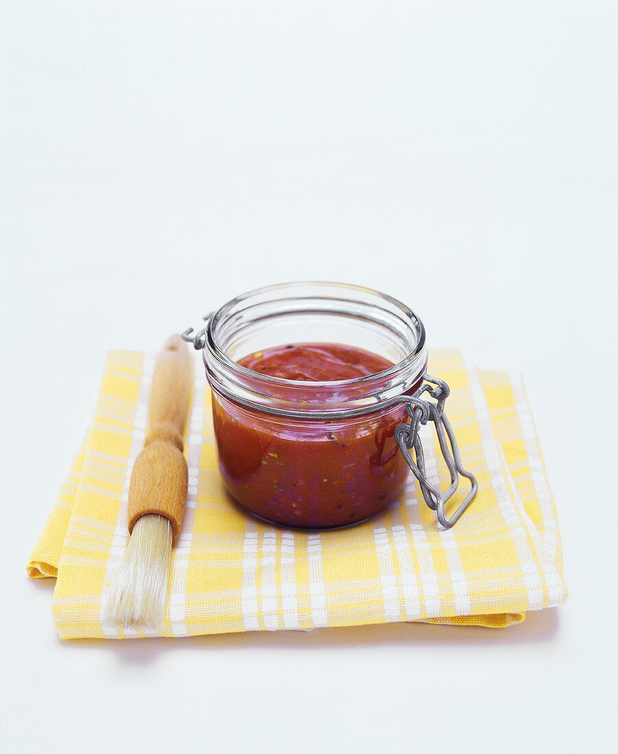 BBQ sauce in jar with brush