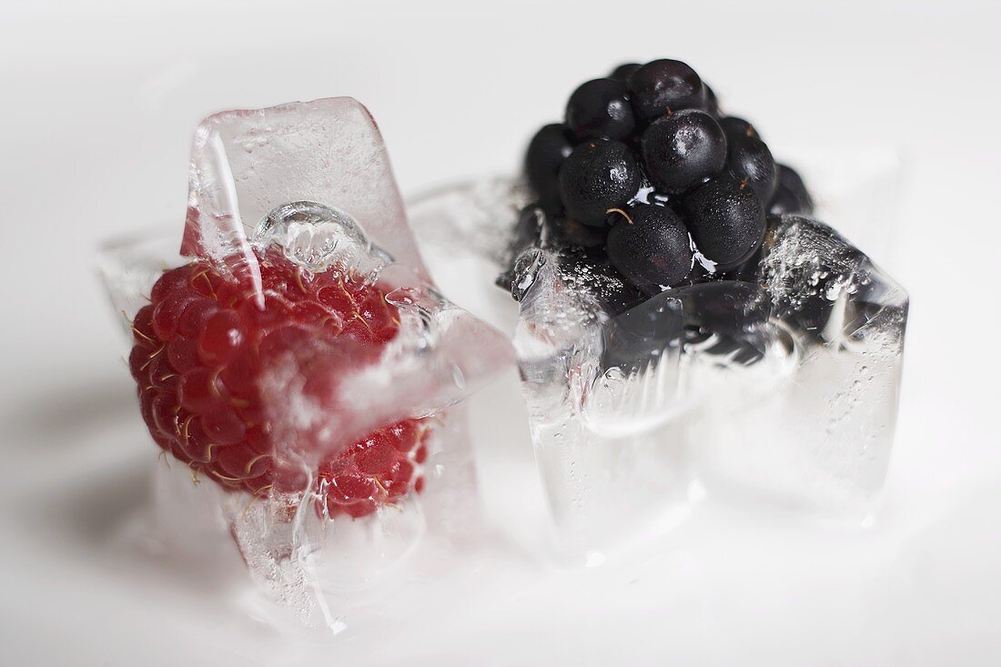 A blackberry ice cube and a raspberry ice cube
