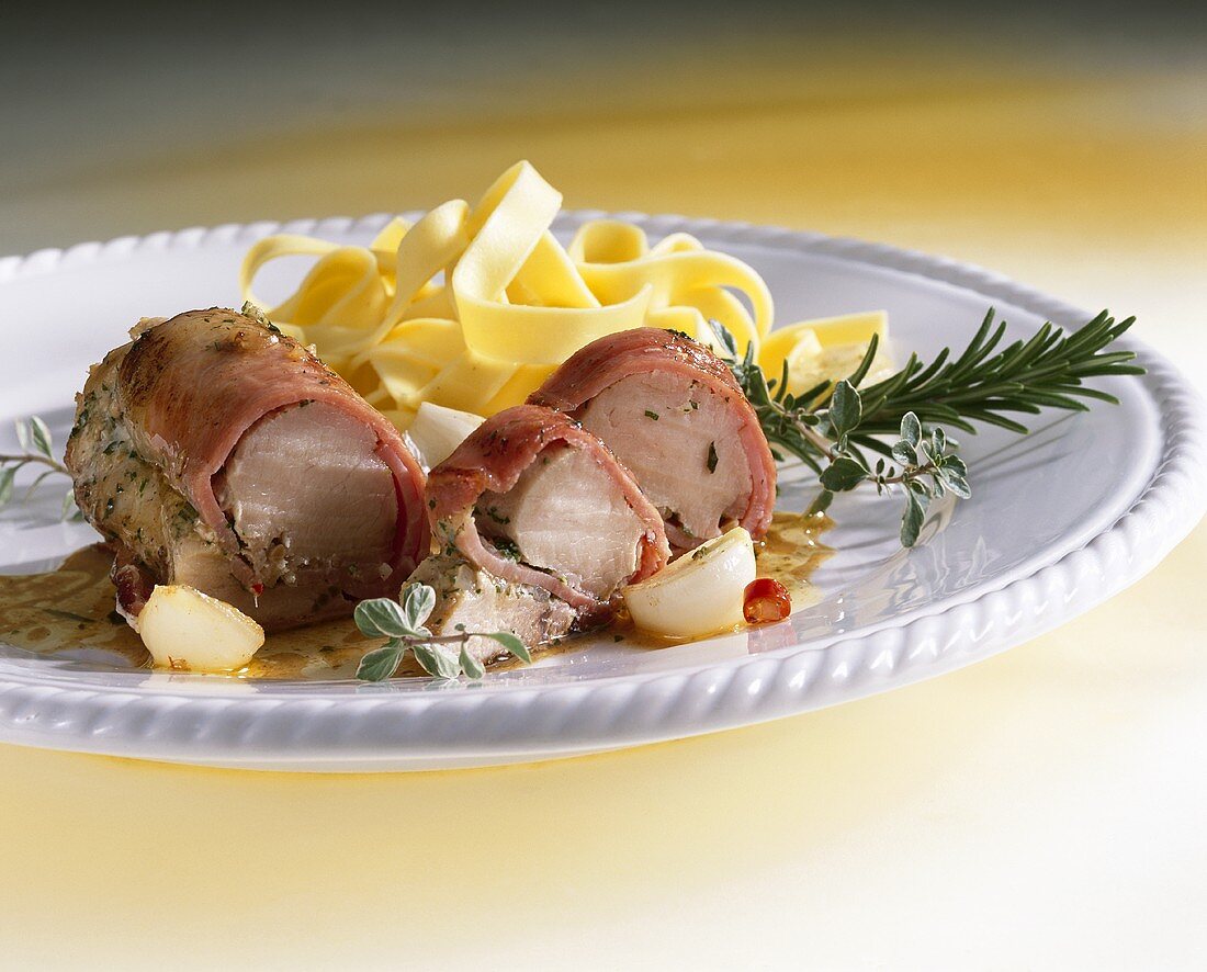 Rolled ham-wrapped rabbit fillet with ribbon pasta