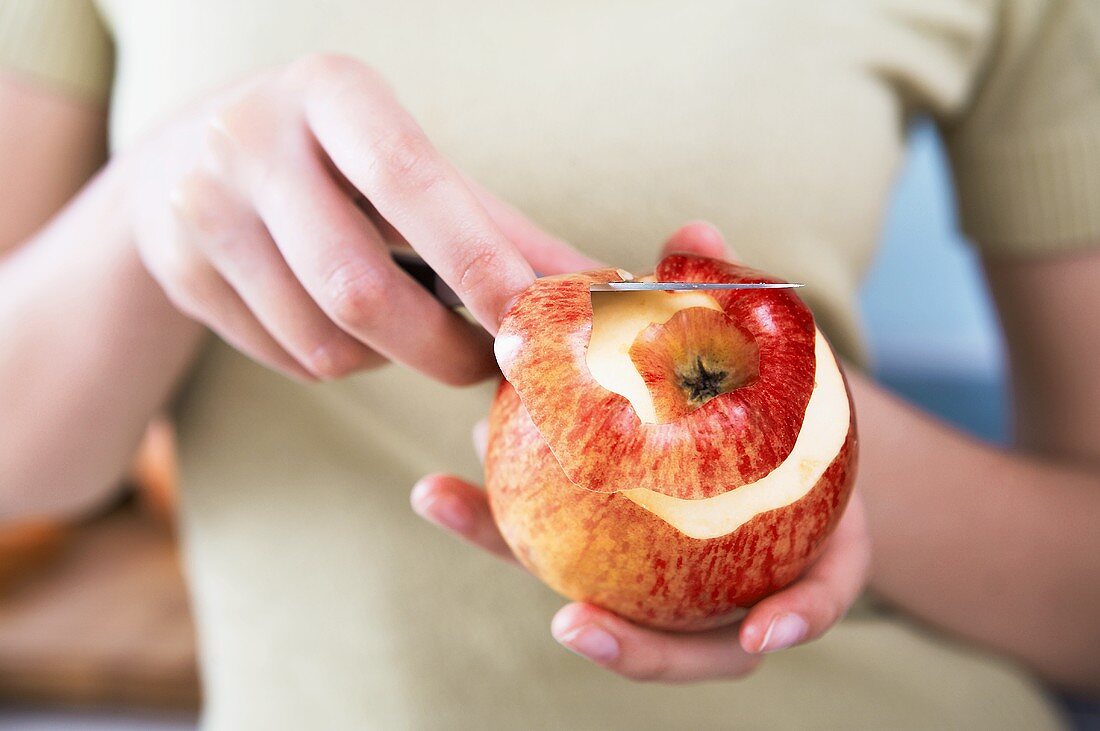 Peeling an apple with a knife